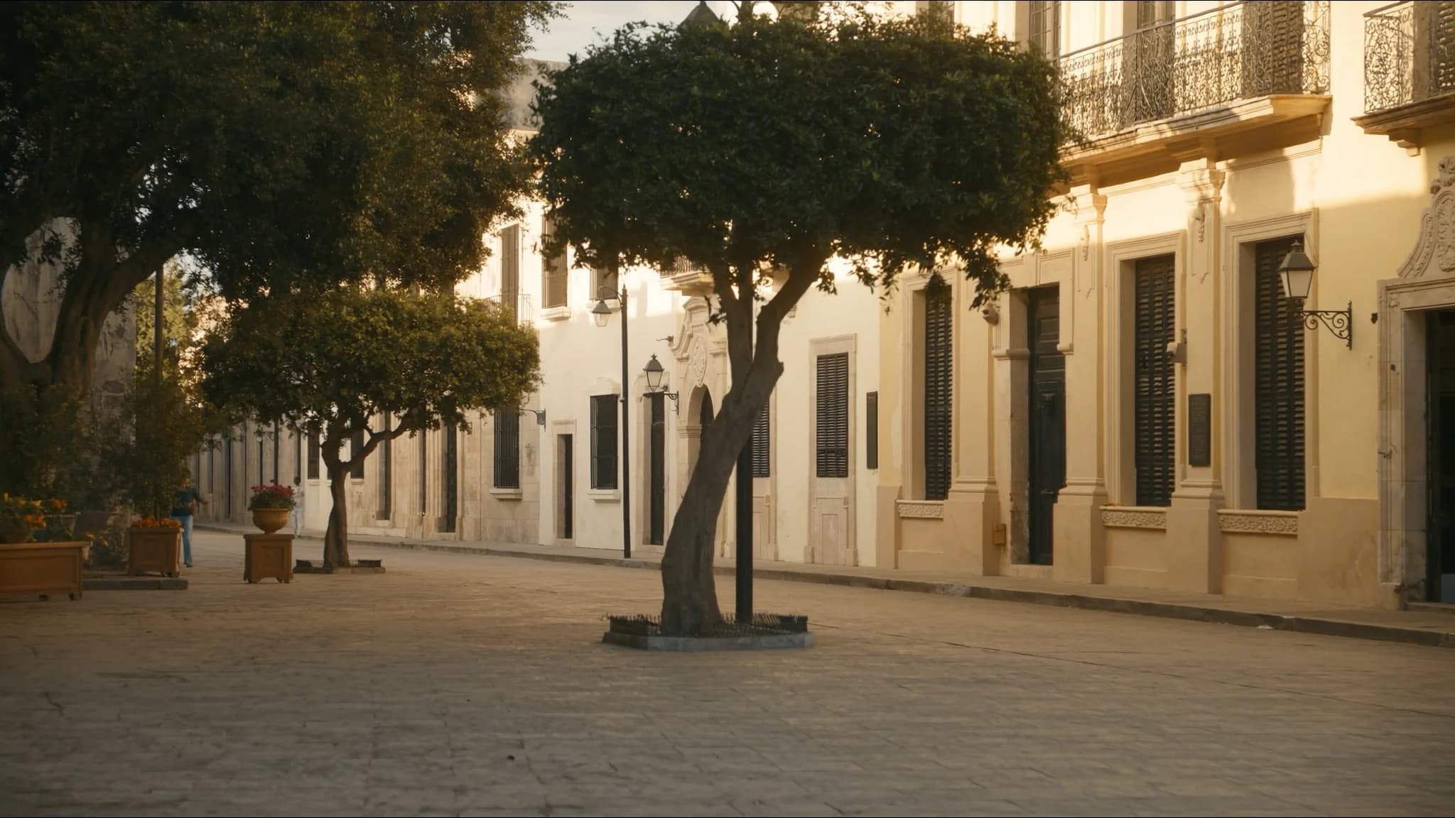 A quiet colonial street in Merida's historic centre at golden hour — illustrative scene